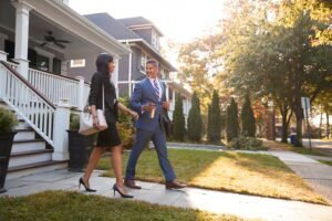 business couple leaving suburban house commute work 1 Ally Bohanan Real Estate | Luxury Real Estate in Gastonia, NC
