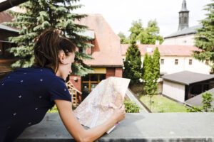 woman looking map near houses Ally Bohanan Real Estate | Luxury Real Estate in Gastonia, NC